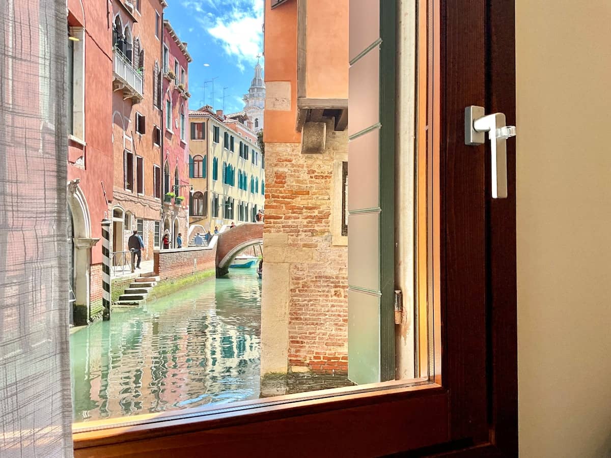 A canal in San Marco seen from an open window at Cà del Volto.