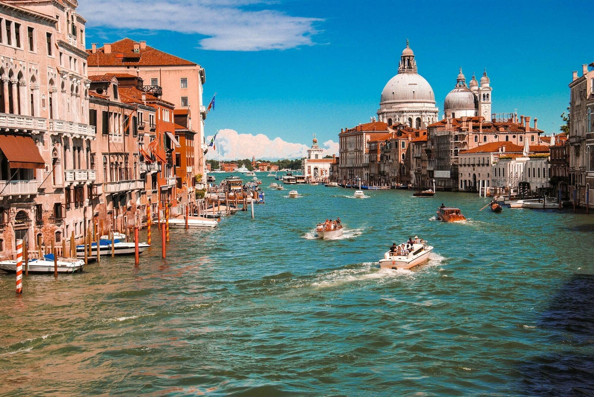 The Grand Canal of Venice with palazzi lining both sides, morning light on the water.