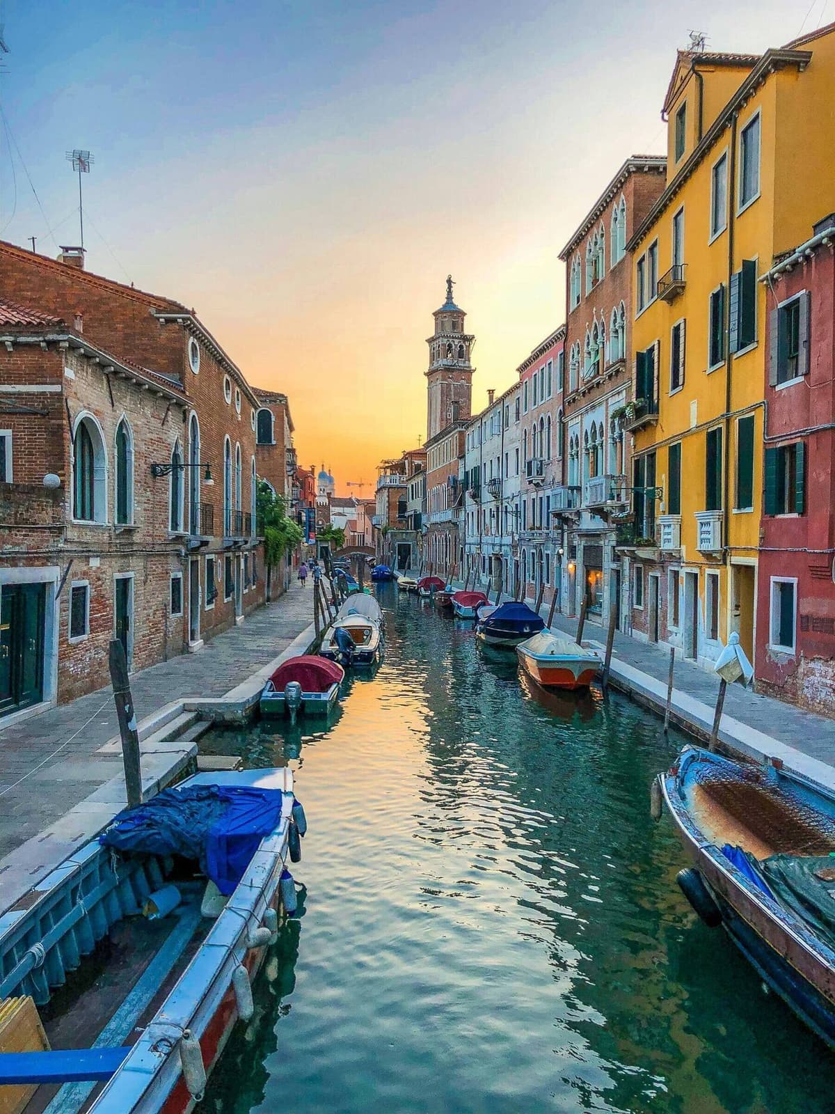 Working boats moored along a residential fondamenta in the Cannaregio sestiere of Venice.